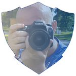 Franky Ireland holding a camera in-front of his face which gives an idea that he is capturing an image